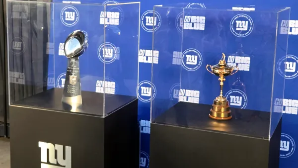 The Ryder Cup trophy on display alongside the Lombardi Trophy.