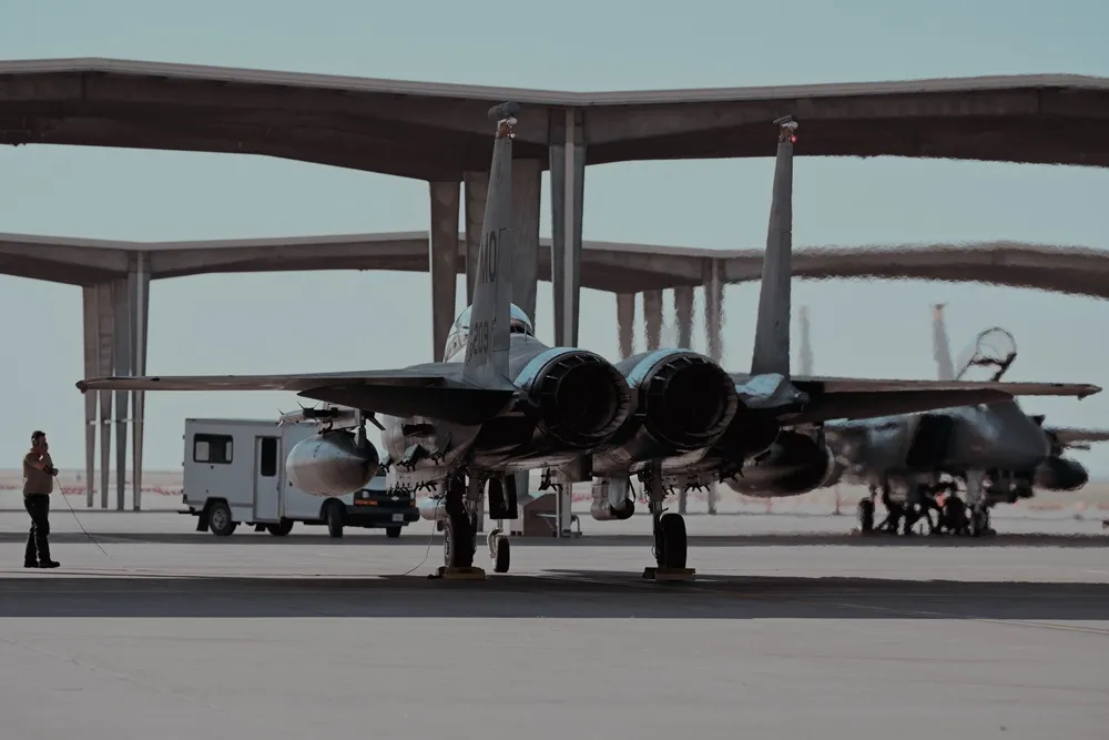 U.S. Air Force airman prepares an F-15E Strike Eagle to taxi the runway.